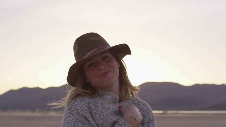 Woman in  brimmed hat smiles