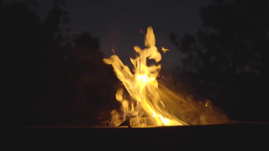 Campfire burns at night
