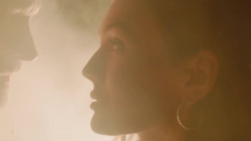Man and woman stare at each other with smoke surrounds them