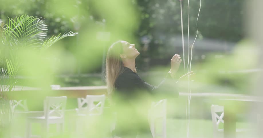 A woman placing balloons outdoors
