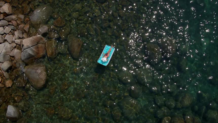 A woman laying on a raft in the water