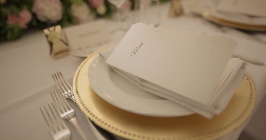 Plates, napkins, and forks are placed on a table