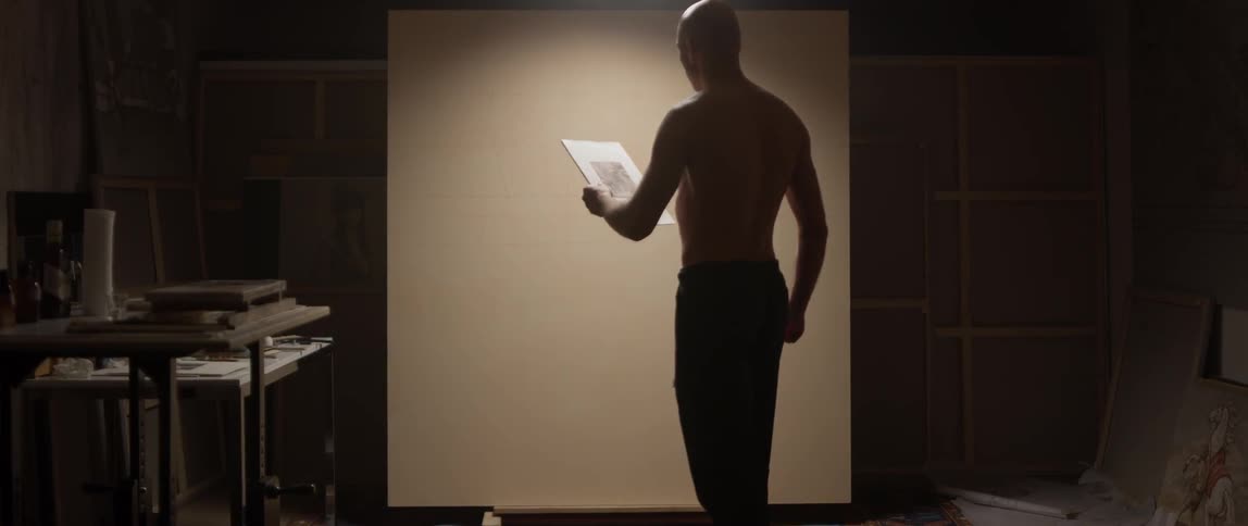 Man walks up to a blank canvas and starts sketching