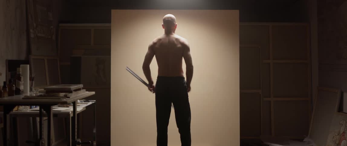 A man drawing a line on a wall