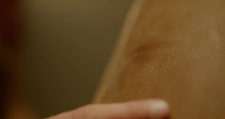 Man runs fingers along a piece of leather