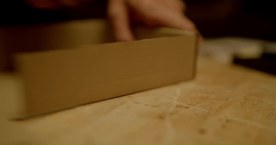 Person folds cardboard into box