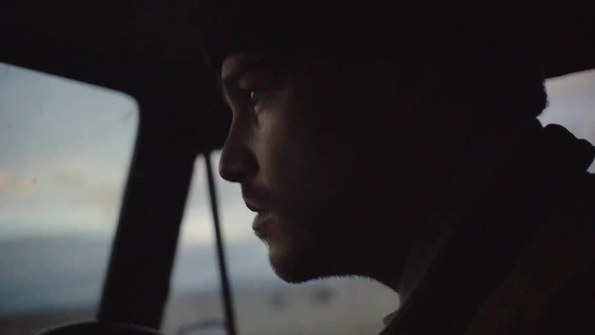 A man drives a truck down the road