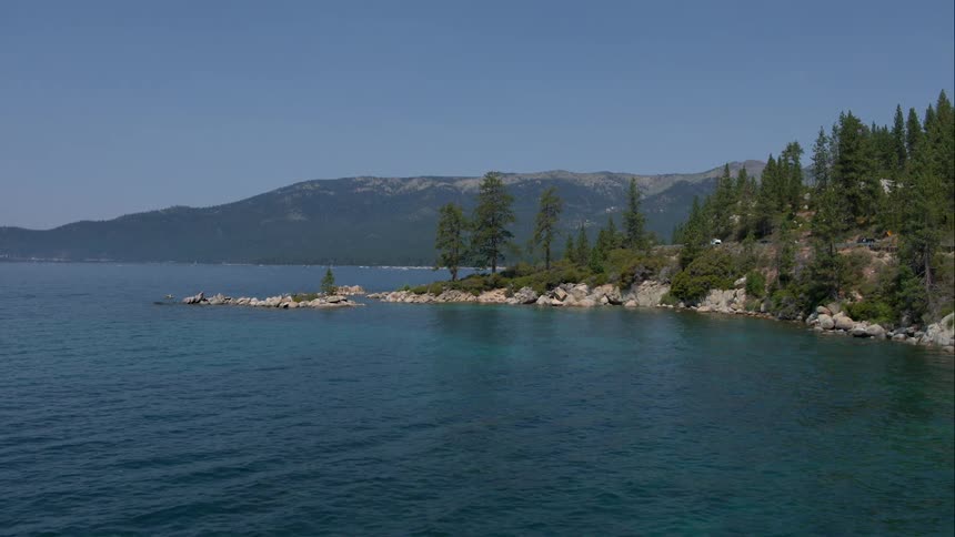 A large lake that is at the base of a mountain