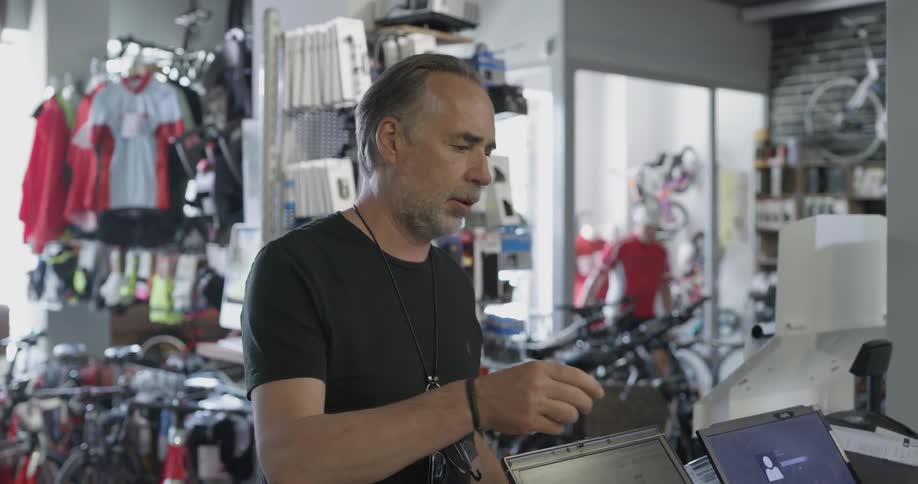 Man paying with his cell phone at a bicycle shop
