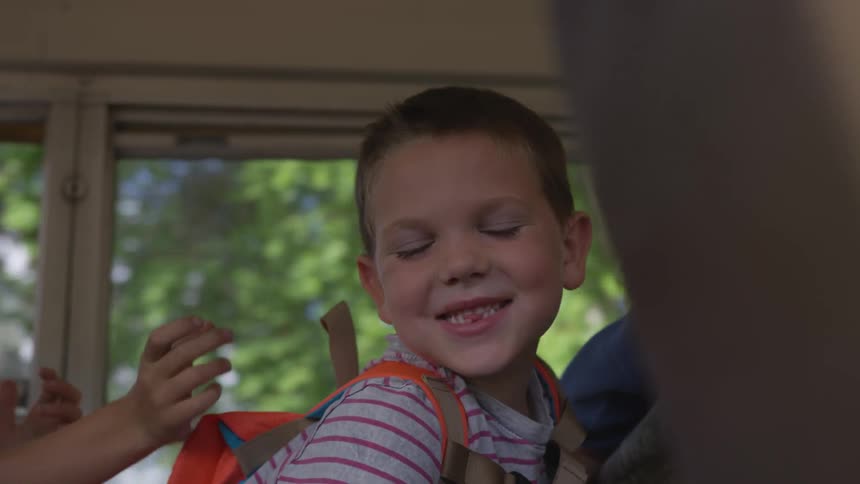 Boy smiling in a moving bus