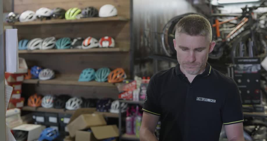 A bicycle shop employee helps a customer