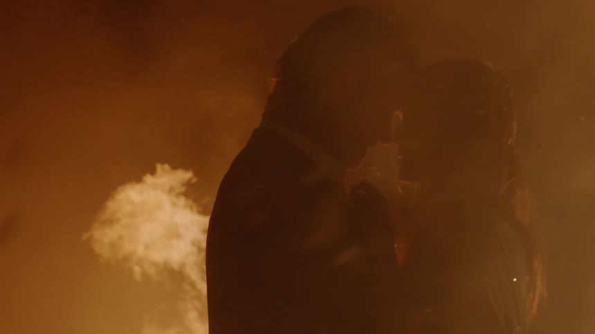 Couple Kissing By Fire In Desert