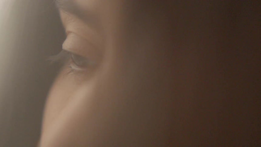 A woman with brown hair is staring