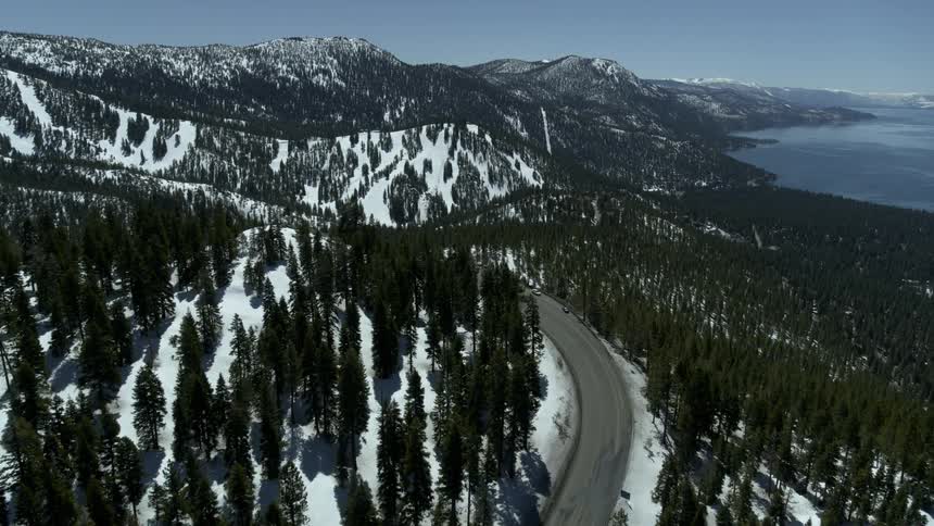 Highway winding through snowy forest in the mountains