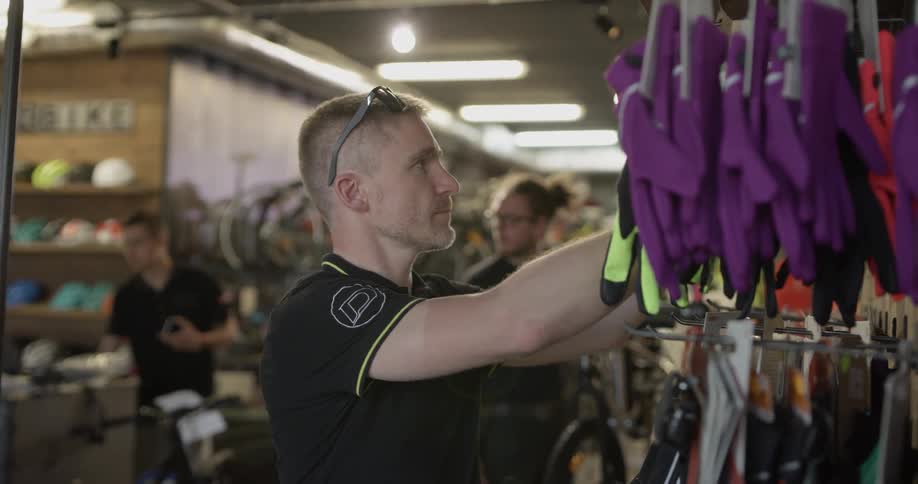 A bicycle shop employee checks the stock