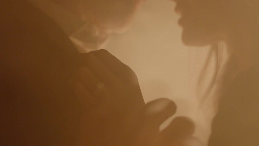 A man and woman standing in a smokey area