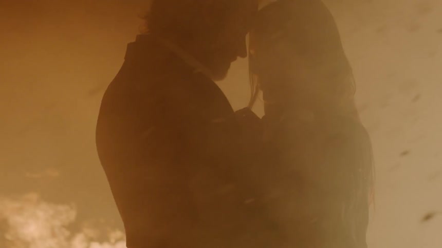 Man and woman holding each other in a plume of smoke