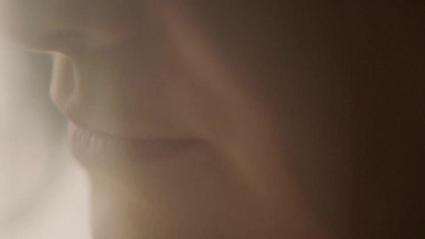 A woman is smiling by herself