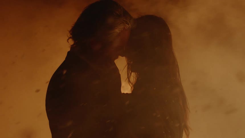 Couple Kissing By Fire In Desert