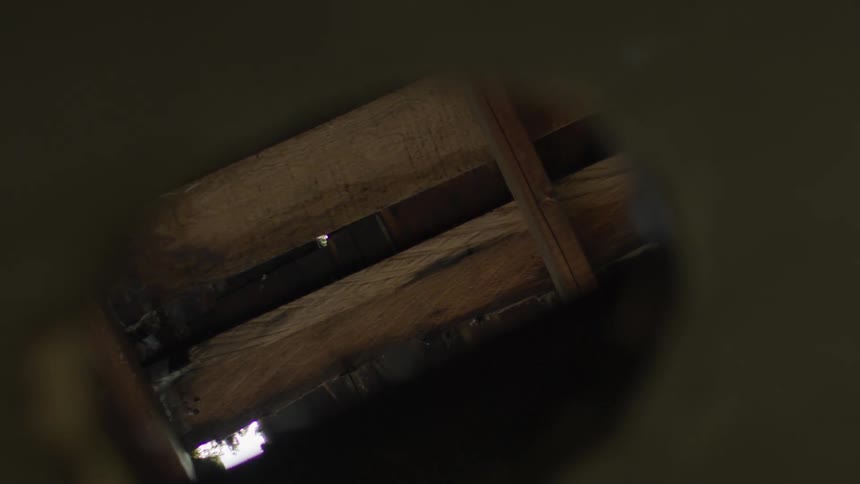 There is a wooden fence that is dusty