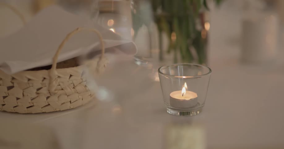 A tea candle burning on a table