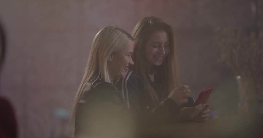 Two women are taking pictures together