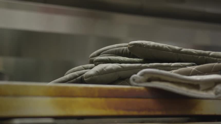 There are oven mitts on a table