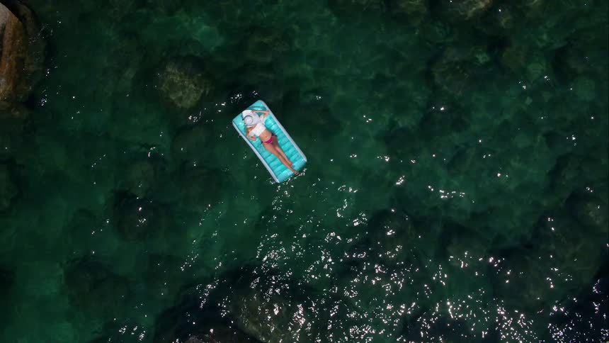 A woman floating on a raft in a lake