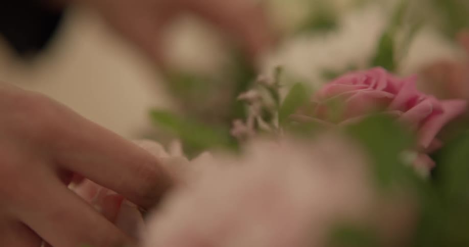 A person is picking through a bouquet of flowers