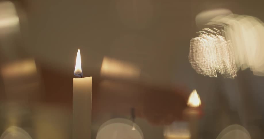 A person lighting a candle with a lighter
