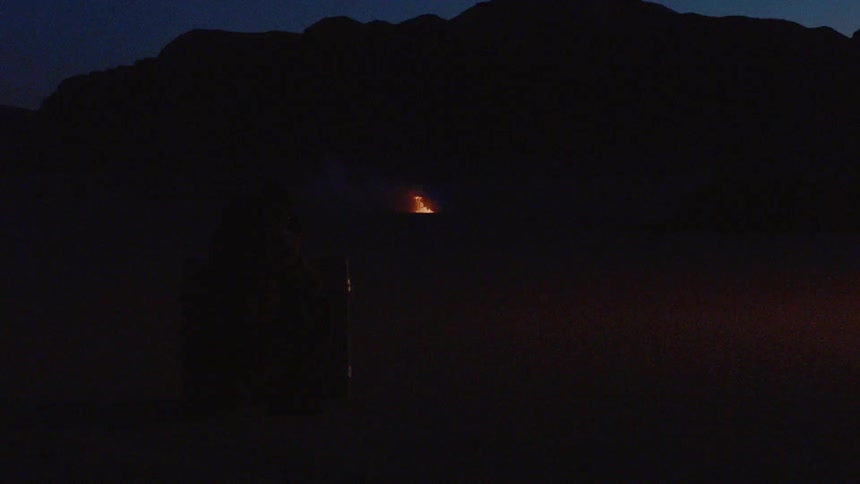 Couple Kissing By Fire In Desert