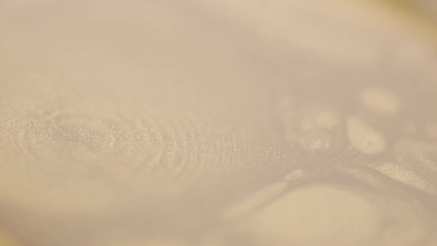 A cup full of water with ripples in it