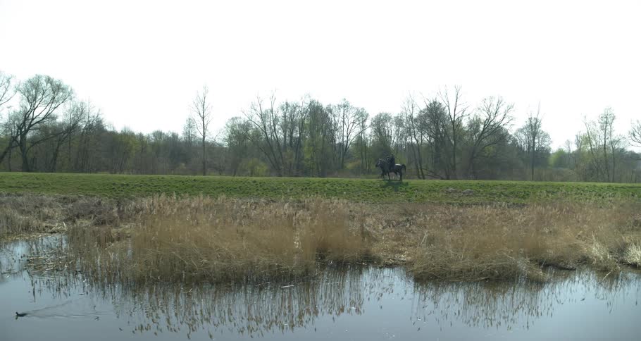 Horses are ridden next to the water