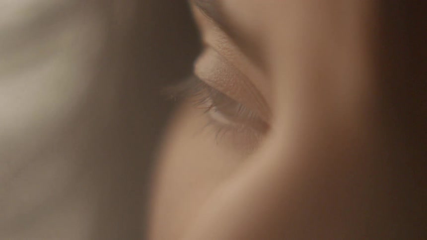 A woman slowly opens her eye