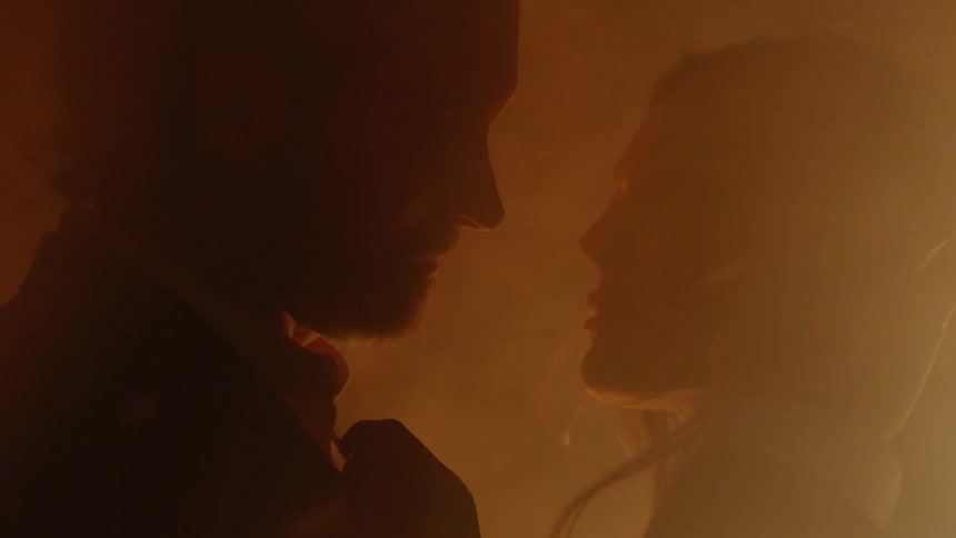 A man is holding a woman closely