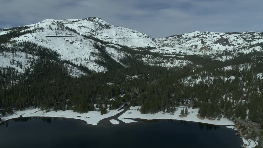 Snow capped mountains by the water
