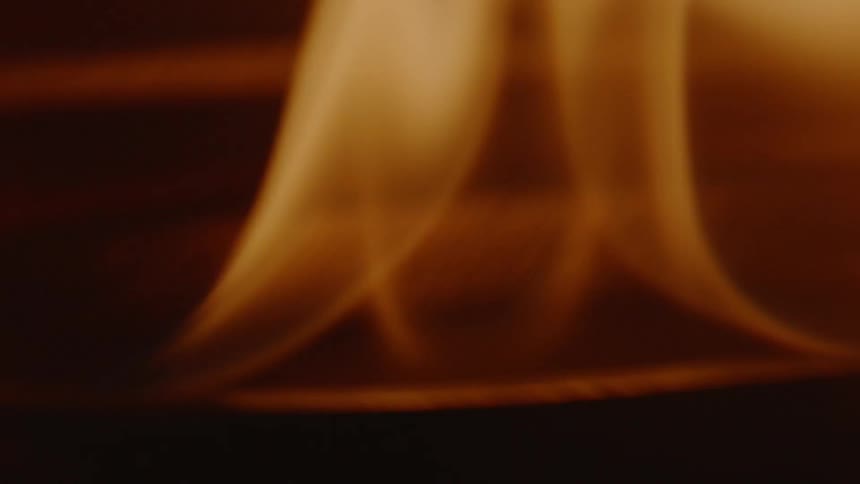Fire on a candle that is on a table
