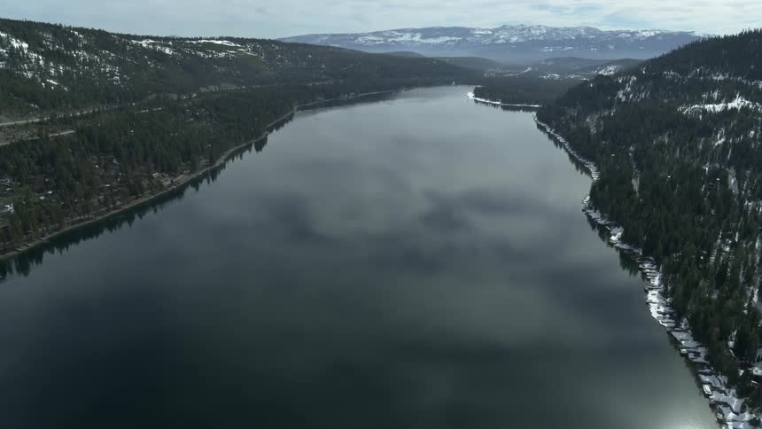 A long body of water in between the mountains