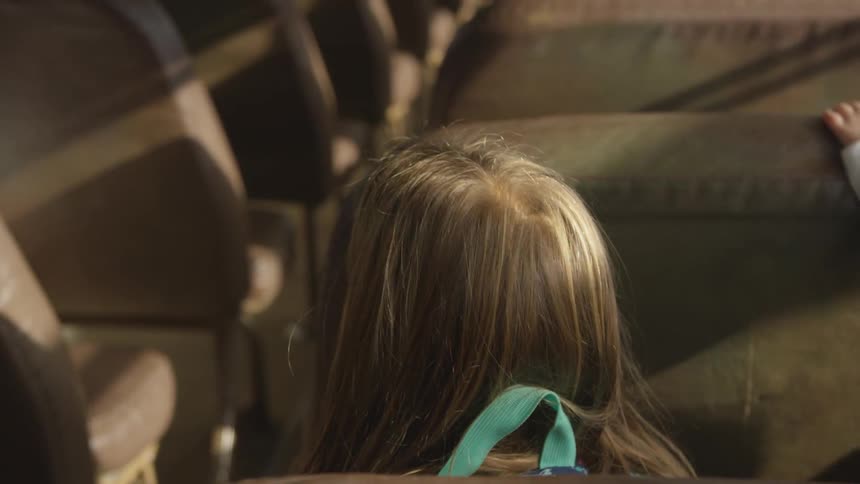Woman sitting in a row of seats