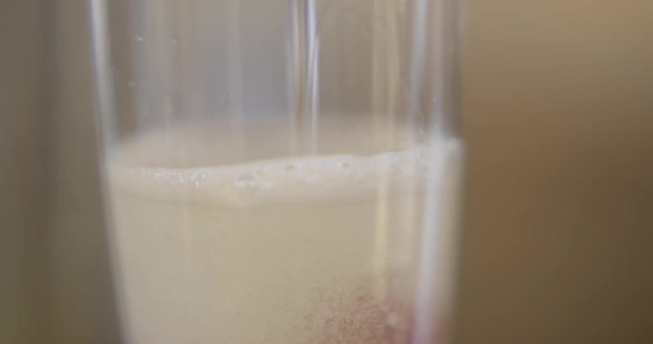 Liquid is being poured into a glass