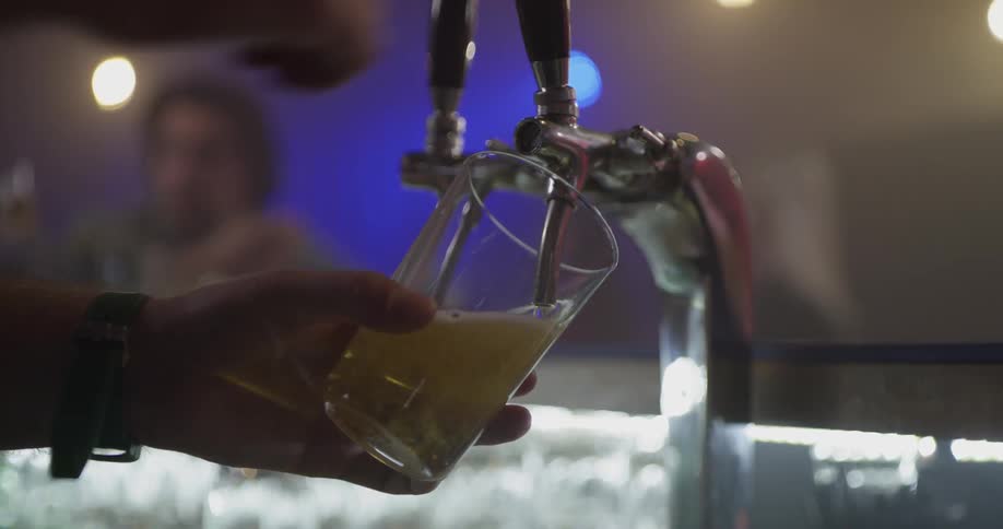 A person is cleaning cups then filling them up with liquid