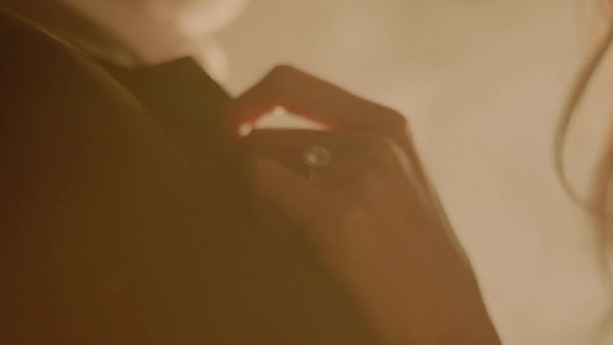 A woman has her hand on a man