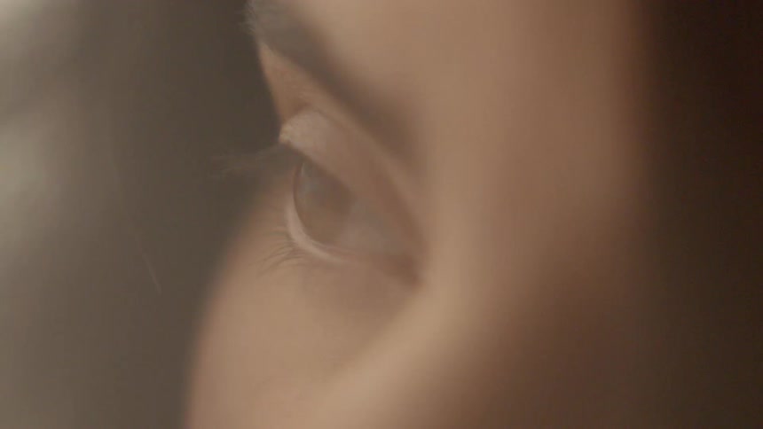 A woman with brown hair is staring