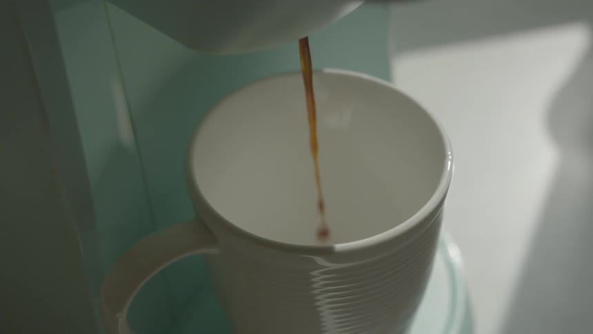 Liquid is being poured into a cup