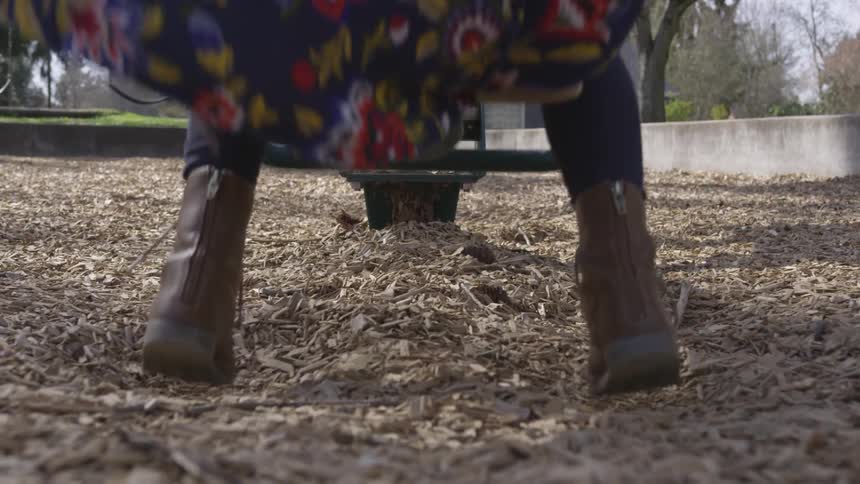 Two people are riding a seesaw in the park