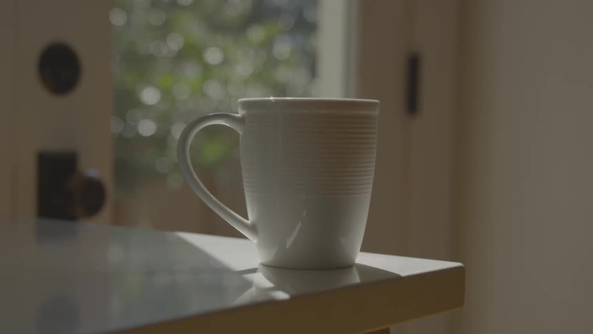 A coffee cup sitting at the edge of a counter
