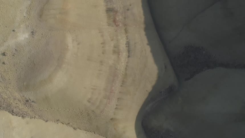 An aerial panning of what appears to be a canyon is shown