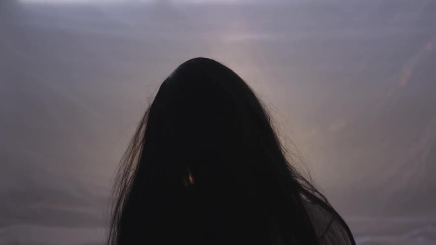 Woman stands gazing at sky