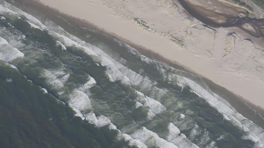 The waves are moving towards the beach