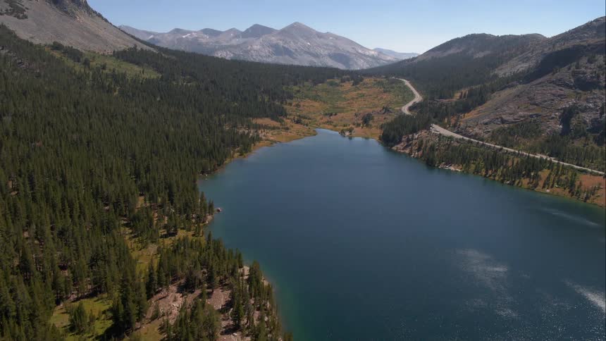 The water is still by the mountains